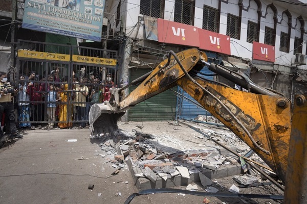 Authorities riding bulldozers razed a number of Muslim-owned shops in New Delhi 