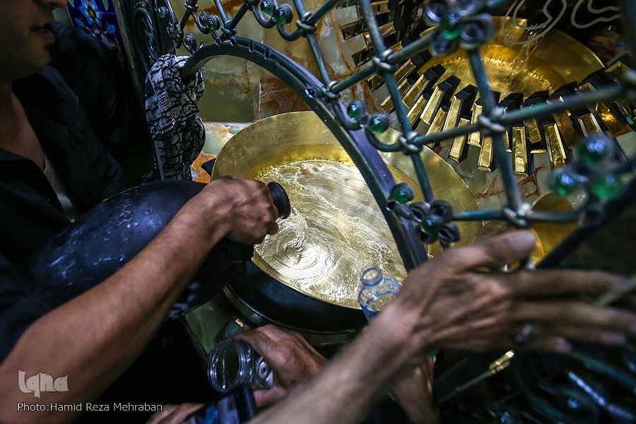 Mourners pour water into washtubs during Tasht-Gozari ritual in a mosque in Tehran in late July 2022.