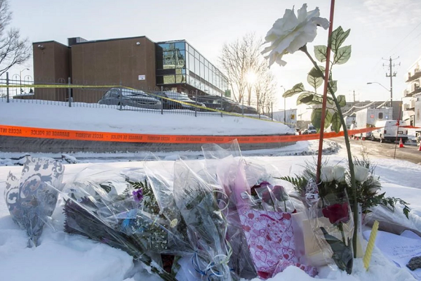 Flowers are seen near a mosque where a shooting left six people dead and eight others injured on Jan. 30, 2017 in Quebec City.