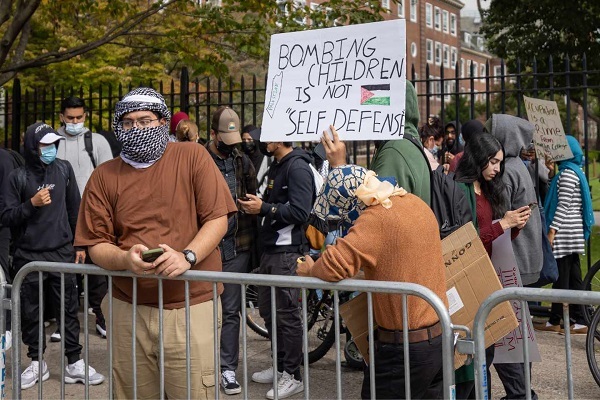 Students from Brooklyn College and supporters hold signs during a pro-Palestinian demonstration at the entrance of the campus on October 12,