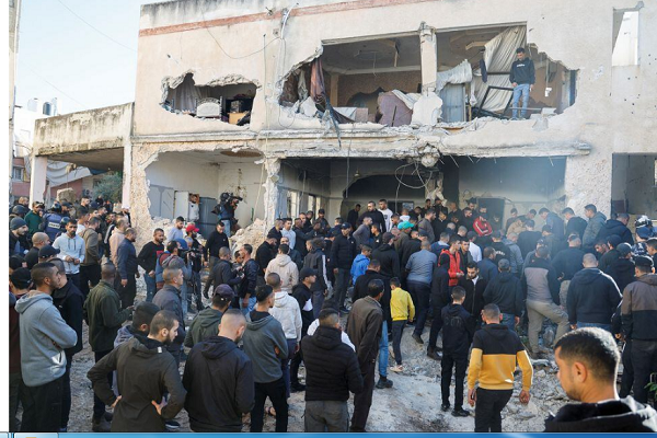 Palestinians check damage following a raid in Jenin in the Israeli-occupied West Bank