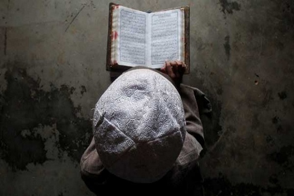 An Indonesian boy reading the Quran