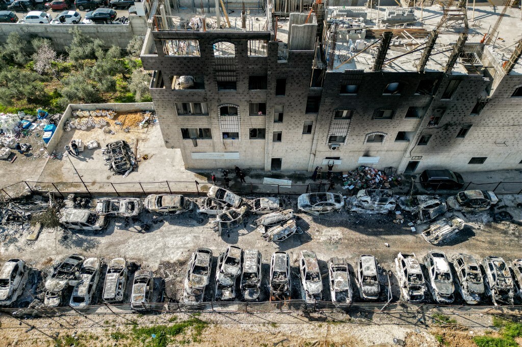 This picture taken on February 27, 2023 shows an aerial view of a scrapyard where cars were torched overnight, in the Palestinian town of Huwara near Nablus in the occupied West Bank. (Photo by AFP)