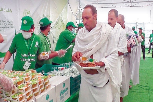 Hajj pilgrims being served meals