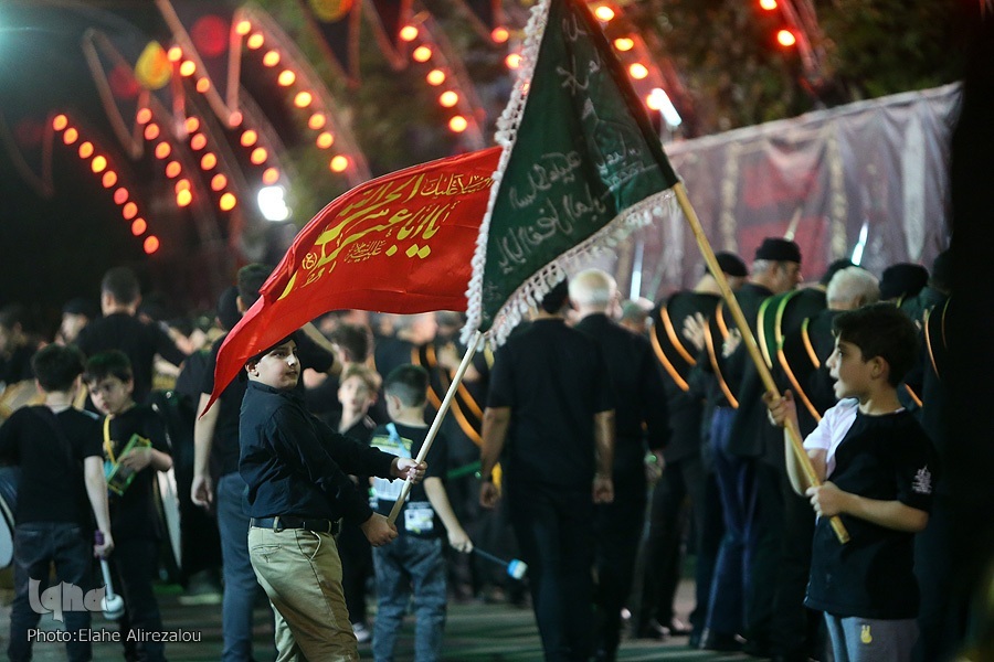 Iranian teenagers wave flags during mourning processions for Imam Hussein (AS) in Tehran on July 27, 2023.