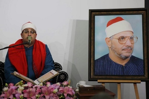 Mahmoud Shahat Anwar and a photo of his father