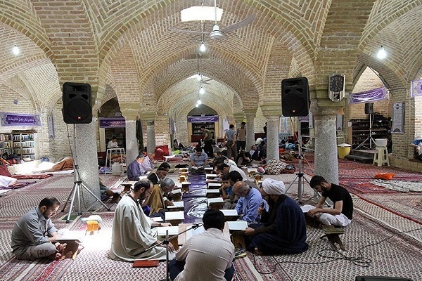 People taking part in an Itikaf ritual in a mosque in Iran