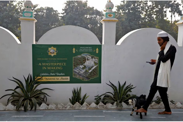 A Muslim man walks his goat at a site that was allotted by authorities for a new mosque in Ayodhya in the northern state of Uttar Pradesh, India