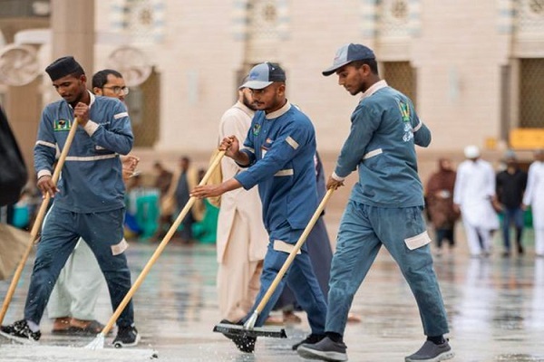 Workers cleaning the courtyard of the Prophet's Mosque in Medina