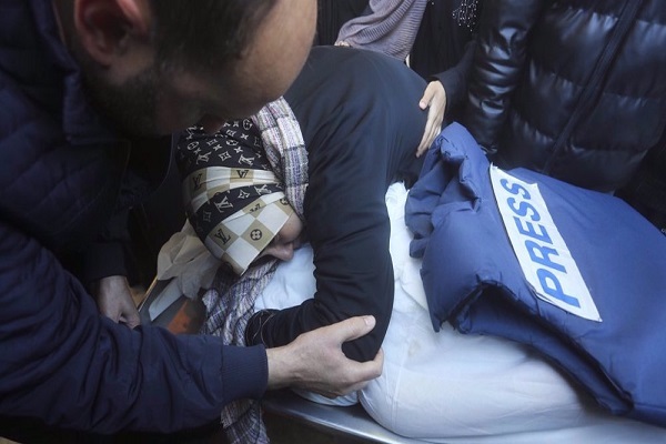 A relative mourns Palestinian journalist Akram al-Shafiei in January 2024, after he was killed in an Israeli bombardment of Gaza.