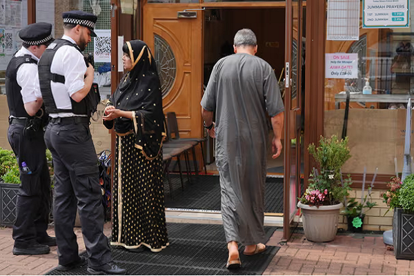 A Muslim woman speaking to police officers in Britain