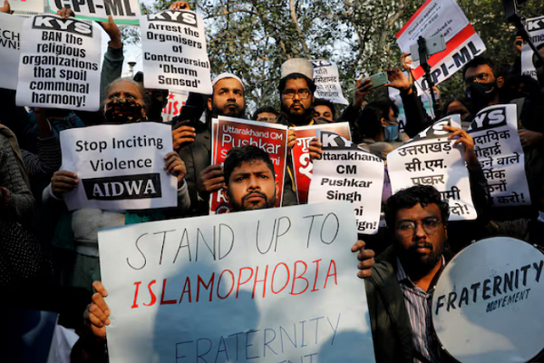 Demonstrators hold placards during a protest against hate speech against Muslims by Hindu leaders, in New Delhi, India, December 27, 2021