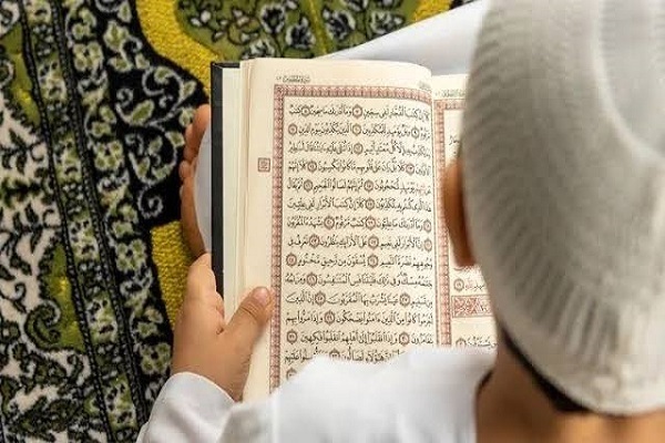 A boy reading the Holy Quran