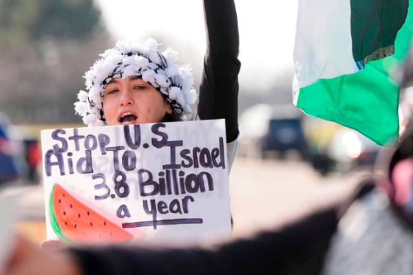 Amana Ali joins about three dozen people protesting Israel's attacks in Gaza, Thursday, Feb. 8