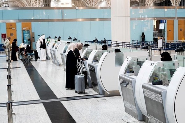 Umrah pilgrims arriving at an airport in Saudi Arabia