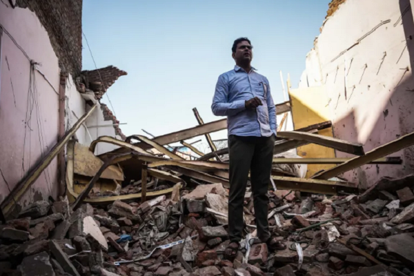 Wakeel Hasan, 45, a rat-hole miner who became a national hero after leading the team that saved 41 trapped workers during a tunnel rescue in December, stands on a rubble-filled plot where his house was demolished by municipal authorities in New Delhi, India