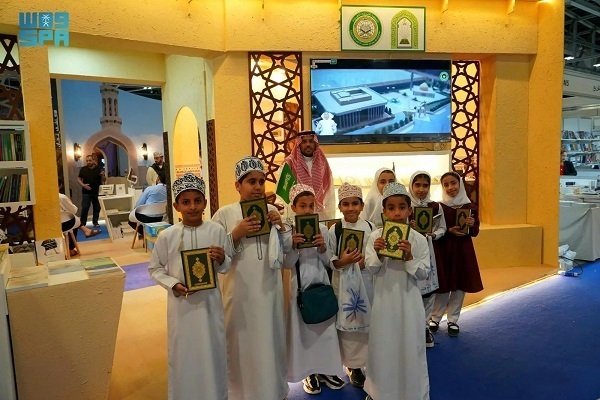 Visitors to the 28th international book fair in Oman’s capital receive copies of the Quran as a gift