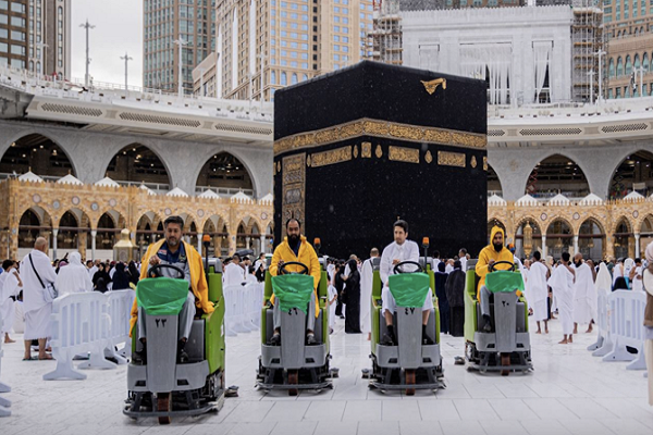 Employees remove water from the mataf during rainfall at the Grand Mosque in Mecca