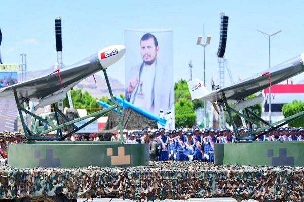 Yemeni forces parading their military assets along a poster of Ansarullah leader Abdul-Malik al-Houthi in capital Sana'a.