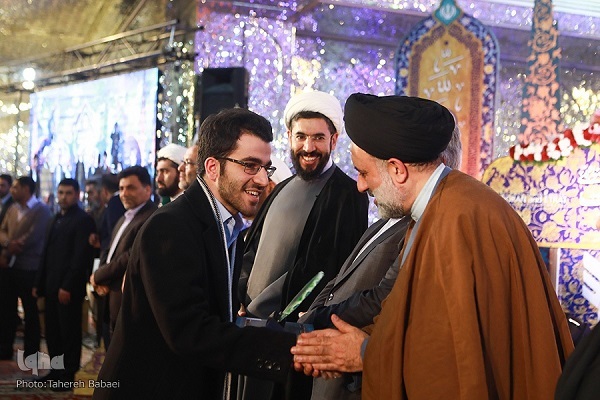 Iranian Quran memorizer Milad Asheqi shaking hands with a senior cleric