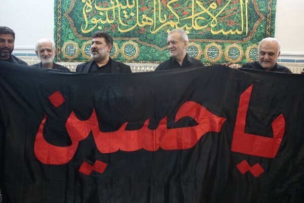 Iranian President-elect Masoud Pezeshkian receives a flag of Imam Hussein’s (AS) holy shrine as a gift.