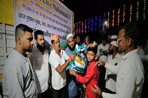 Volunteers handing over a relief package to a young boy in a relief camp in Maharashtra's Marathwada region in India.