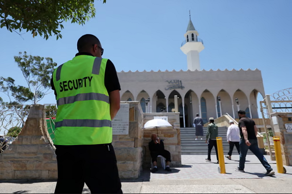 A security guard stands outside the Lakemba mosque in Sydney, Australia, as people arrive for Friday prayers