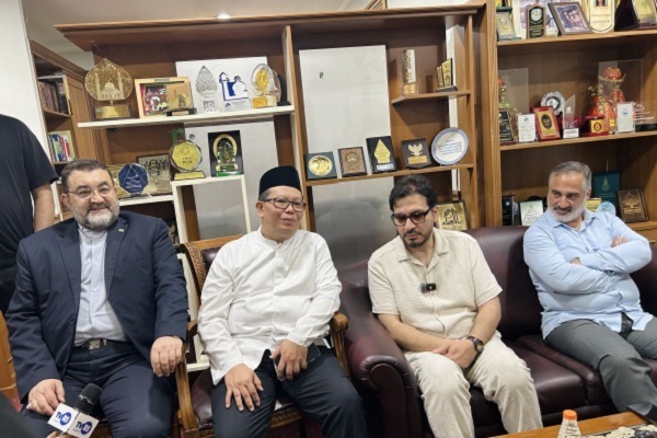 Iran’s Ambassador to Indonesia Mohammad Boroujerdi (left)