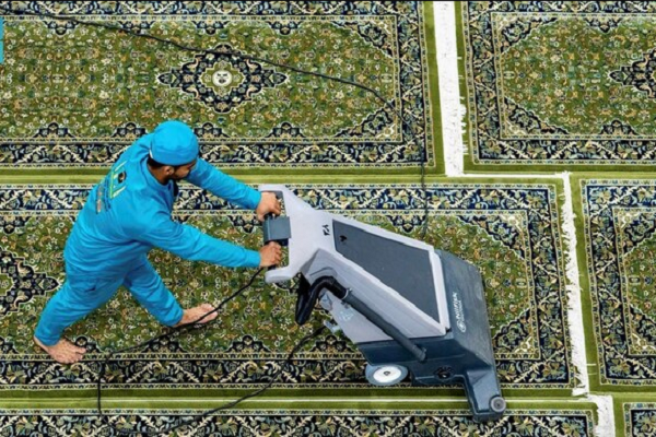 A worker cleaning carpets at the Grand Mosque in Mecca