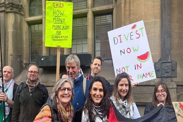 Outside the Oxford City Council meeting, dozens of Oxford residents held a silent vigil with signs saying “Divest now” and “Not in our name”, March 24, 2025.
