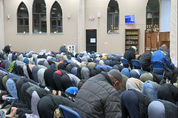 Members of the Muslim community in West Michigan performing prayer after breaking fast together.