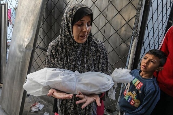 A mother holds her baby killed in Israeli attacks on Gaza