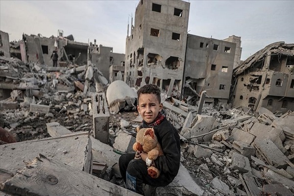 A little boy in the middle rubble of buildings destroyed in Israeli attacks on Gaza