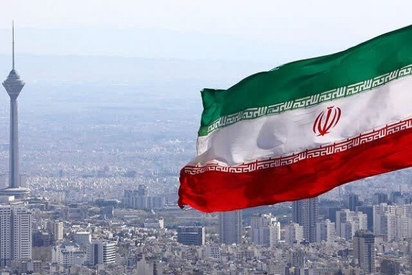 A flag of Iran with the capital Tehran in background