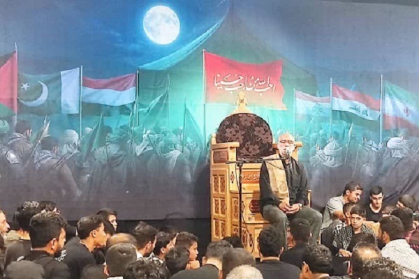 A member of the 2025 Arbaeen Quranic Convoy, known as the Imam Reza (AS) convoy, reciting the Quran at a program in Iraq.