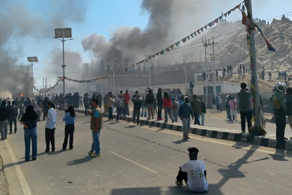 Smoke rises from a police vehicle that was torched by the demonstrators near the Bharatiya Janata Party (BJP) office in Leh on September 24, 2025.