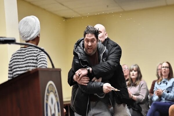 A man assaulted US Muslim Representative Ilhan Omar on Tuesday, spraying her with a dark-colored liquid during a town hall meeting in Minneapolis.