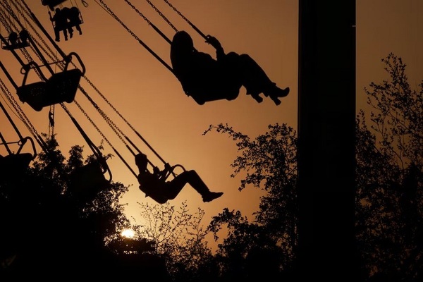 Baghdad residents take a ride at an amusement park at sunset, as they celebrate Eid Al Adha in Iraq's capital. Reuters

