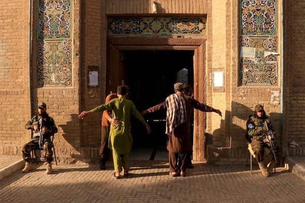 Security personnel frisk devotees entering Jami mosque in Herat, western Afghanistan, to offer Eid Al Adha prayers. AFP

