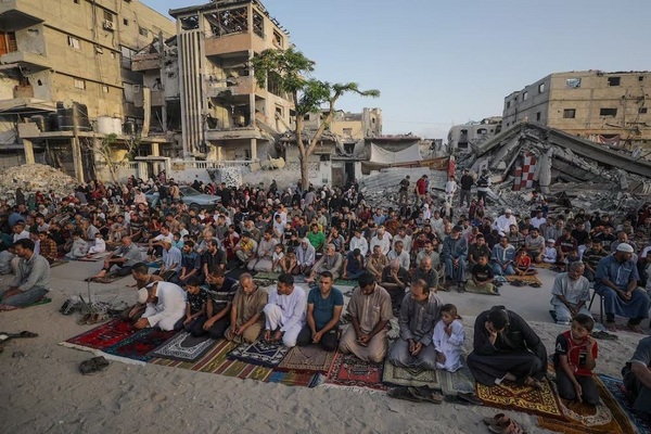 Palestinians attend Eid Al Adha prayers in Khan Younis, southern Gaza. EPA


